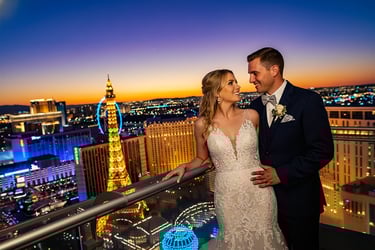 a bride and groom standing on a balcony balcony