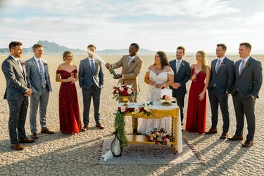 a bride and groomsmid standing in front of a desert