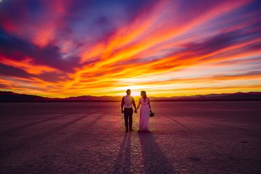 a couple holding hands while walking through the desert