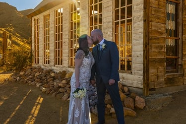 a man and woman standing in front of a church