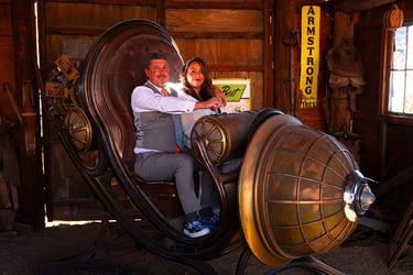 a man and woman sitting in a chair
