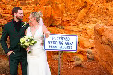 a man and woman standing next to a sign that says reserved