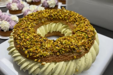 Gourmet pastry with piped cream and crushed pistachios.