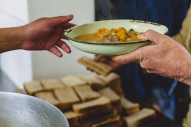 a person handing another a bowl of food