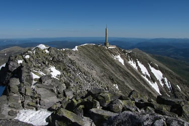 A tall concrete tower stands at the top of a peak-Gausta-istock