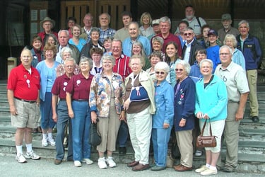 a large group of tour members posing on stairs