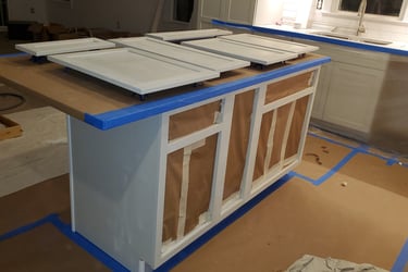 a kitchen island with a counter top and cabinets