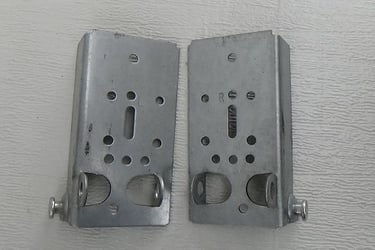 Bottom fixtures for garage door cables.