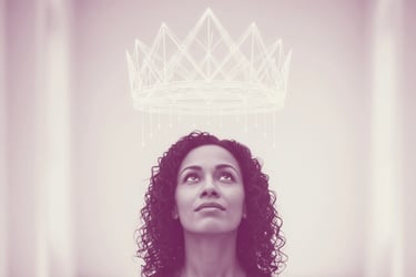 A woman looks up thoughtfully at a symbolic crown of light above her, suggesting an invisible weight