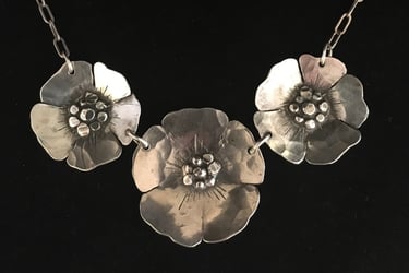 three beach roses on a necklace in sterling silver