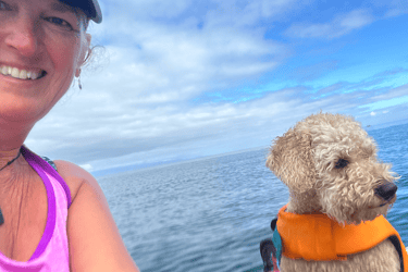 woman and dog on ocean
