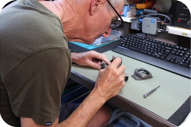Camera technician inspects damaged camera