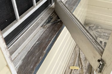 Window sill and frame before repainting showing worn timber and weather damage
