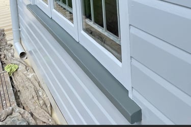 Finished exterior repaint showing clean window trim, sill and weatherboard detail