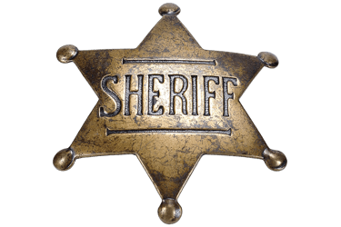 Vintage brass six-pointed star sheriff badge with an aged patina and embossed lettering on a black b