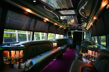 Luxury party bus interior with LED lighting, leather seating, and premium sound system for weddings 