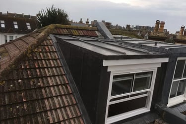 Loft conversion with dormer window added to roof of Brighton home.