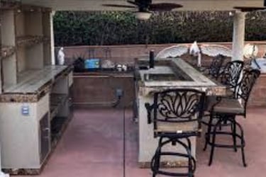 a kitchen with a bar stool and a bar stool