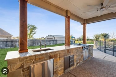 a kitchen with a large outdoor kitchen and a grill
