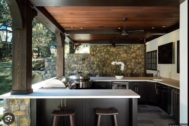 a kitchen with a stone wall and a bar stool