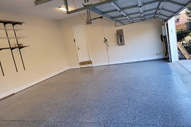 a garage with a garage door open and a garage door open