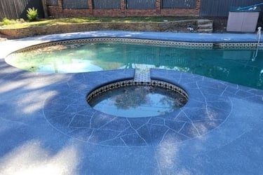 a pool with a hot tub and a pool