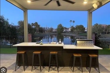 a kitchen with a large outdoor kitchen and a barbeque