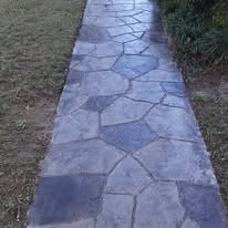a walkway with a bench and a bench in the background