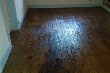 a room with a wooden floor and a window