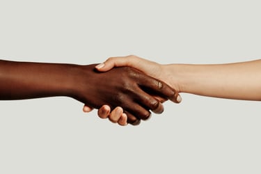Close-up of a diverse handshake between two people symbolizing unity and partnership.