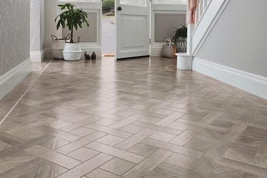 Modern basket weave LVT flooring in a bright home entryway 