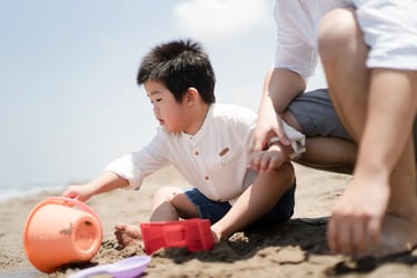 Child playing in the sand during a relaxed family photography session at W Bali Seminyak