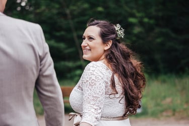 Bride looking at groom while walking.