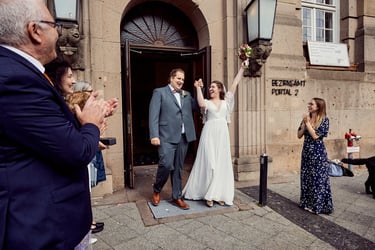 Newlyweds exiting the Tempelhof-Schöneberg civil registry in Berlin.