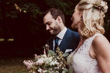 Braut, die den lächelnden Bräutigam ansieht.