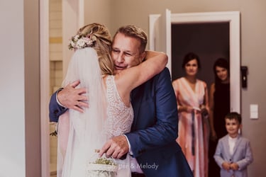Father of the bride hugging his daughter.