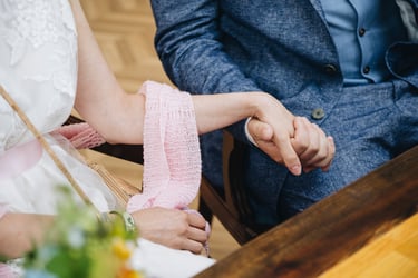 Bride and groom holding hands during the ceremony.