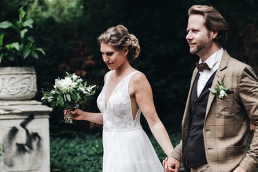 Bride and groom walking holding hands.