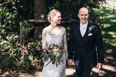 Bride and groom walking in the countryside.