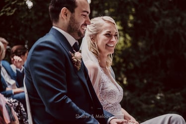 Bride and groom laughing during wedding ceremony.