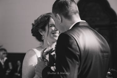 Bride and groom smiling at each other after the ceremony.