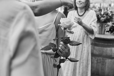 Bride holding a white rose.
