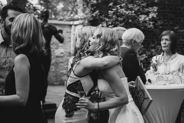 Bride hugging a wedding guest.