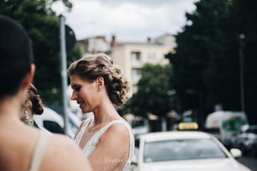 Bride talking to guests on the street.