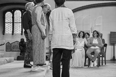 Lesbian couple looking on at a choir singing at church.