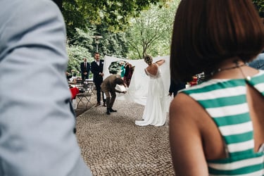 Bride and groom cutting a heart out of bed sheets.