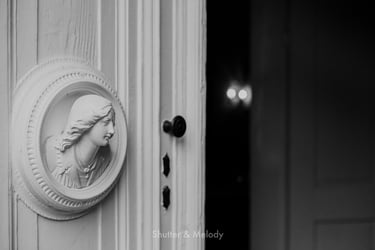 A wooden sculpture on a white door.