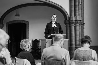 Female pastor preaching during a wedding ceremony.