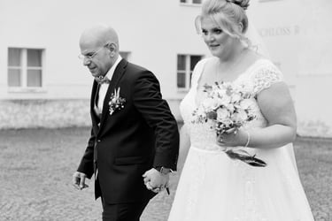 Bride and groom walking in a courtyard.