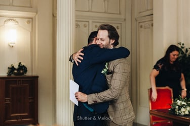 Groom hugging his best man after the ceremony.